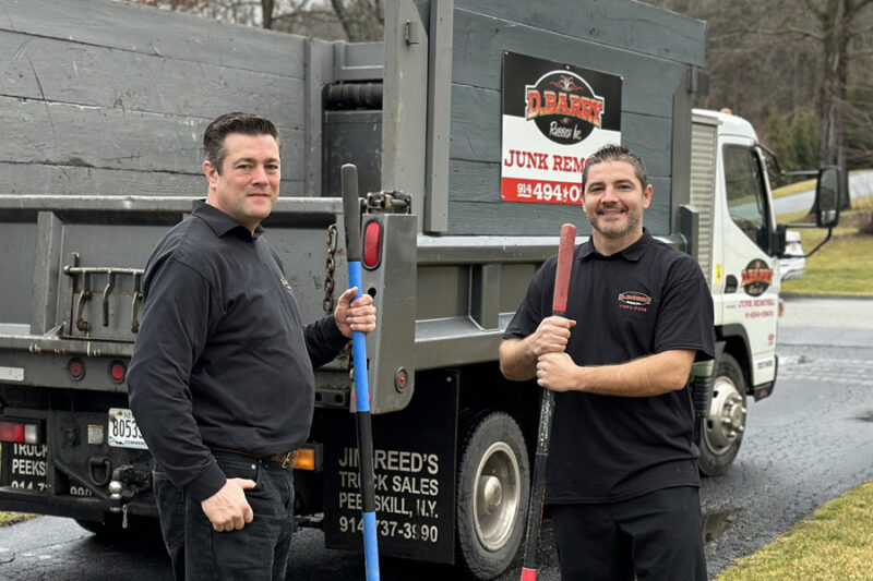 Barry's Junk Removal pros posing with junk removal tools